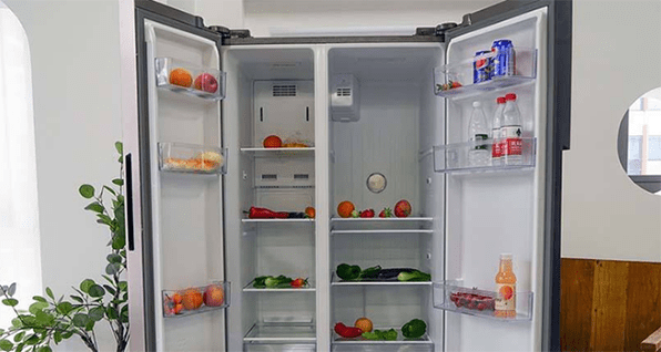 an open refrigerator with some fruits, vegetables and drinks